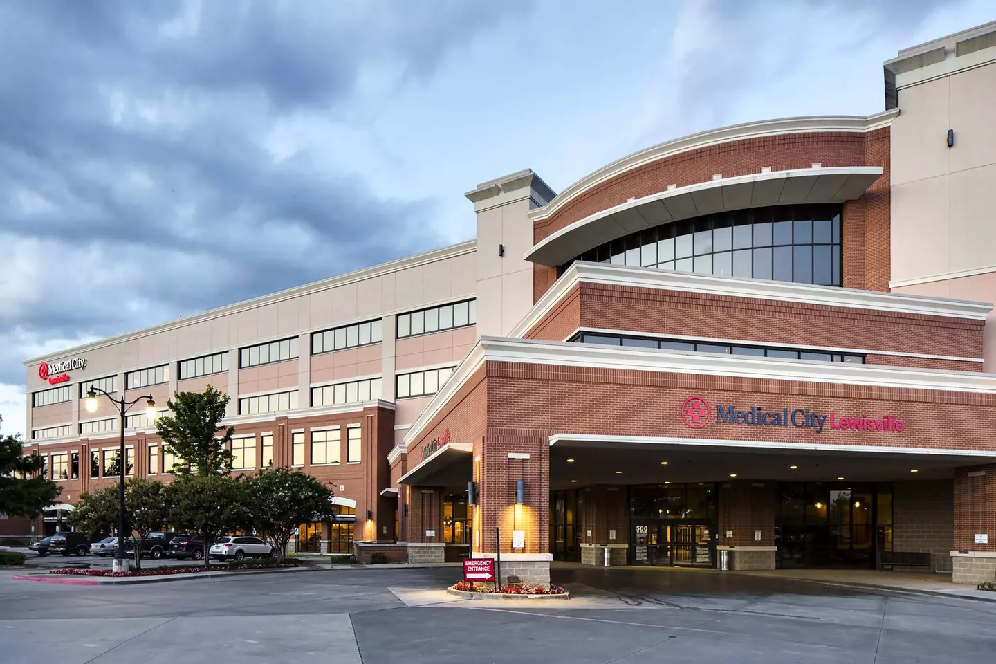 Medical City Lewisville hospital, the main entrance at dusk, one of the two hospitals where Dr. Zaidi operates